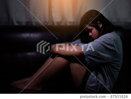 Teenager girl with depression or sad sitting alone in the dark room. major depressive disorder. lonely concept and Health Problems. Teenager girl with depression or sad sitting alone in the dark room. major depressive disorder. lonely concept and Health Problems. 87915826