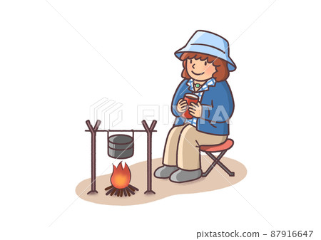 Young woman in solo camp relaxing in front of a bonfire 87916647