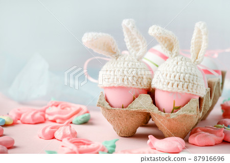 Happy Easter holiday concept with cute handmade eggs, knitted bunny hats and sweet pink decor, copy space. Greeting card, banner for your site, flyer, banner, invitation, discount card Happy Easter holiday concept with cute handmade eggs, knitted bunny hats and sweet pink decor, copy space. Greeting card, banner for your site, flyer, banner, invitation, discount card 87916696