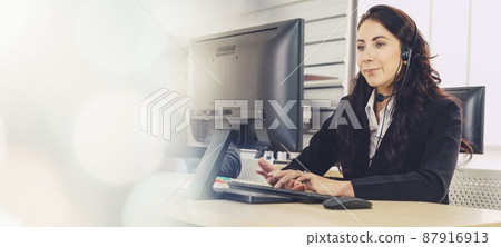 Business people wearing headset working in office broaden view Business people wearing headset working in office broaden view 87916913