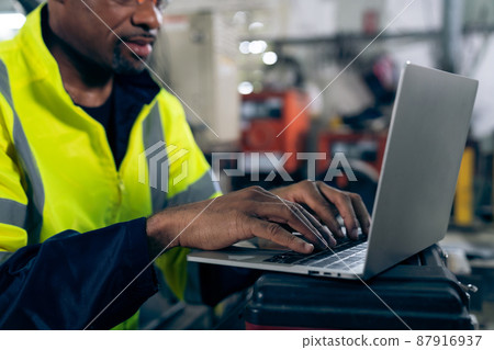 Factory worker working with laptop computer to do adept procedure checklist 87916937