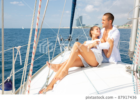Couple sailing on yacht along Spanish coast 87917436