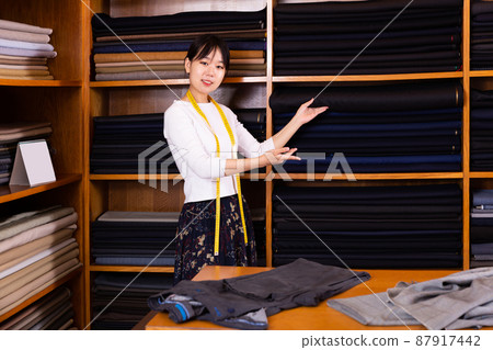 Adult Chinese salesgirl working in fabric store Adult Chinese salesgirl working in fabric store 87917442