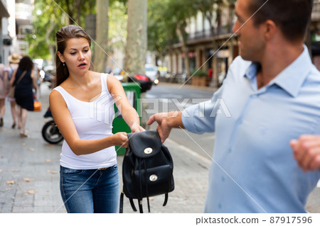 Thief stealing woman bag Thief stealing woman bag 87917596