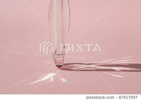 Crystal prism with light diffraction of spectrum colours and reflection with trendy light and hard shadows on pink background. Light spectrum reflected through glass prism. Crystal prism with light diffraction of spectrum colours and reflection with trendy light and hard shadows on pink background. Light spectrum reflected through glass prism. 87917897
