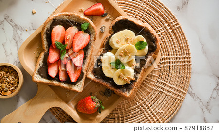Top view, Healthy toasts, Strawberry and banana with dark chocolate spread 87918832