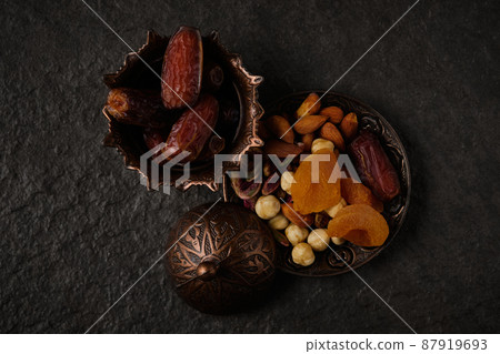 Dates and nut mix at stone background. 87919693