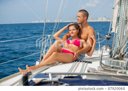 Couple sailing on yacht along Spanish coast Couple sailing on yacht along Spanish coast 87920068