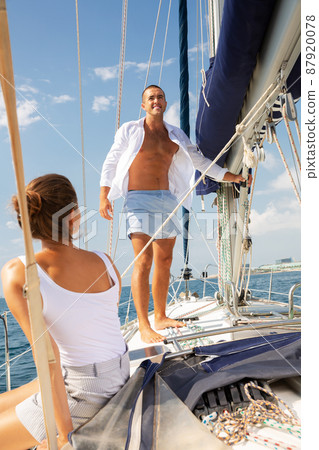 Man on sailboat with woman Man on sailboat with woman 87920078