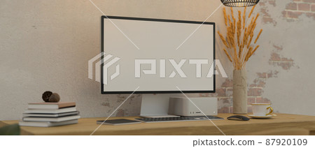 Workstation with modern pc desktop computer mockup against white brick wall. 87920109
