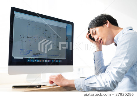 Male electrical engineer worried in front of a computer 87920296