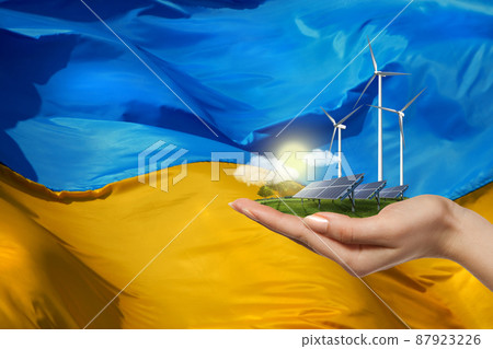 solar panels and wind turbines against flag of Ukraine 87923226