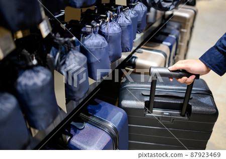 Male hand choosing suitcase luggage in the shop Male hand choosing suitcase luggage in the shop 87923469