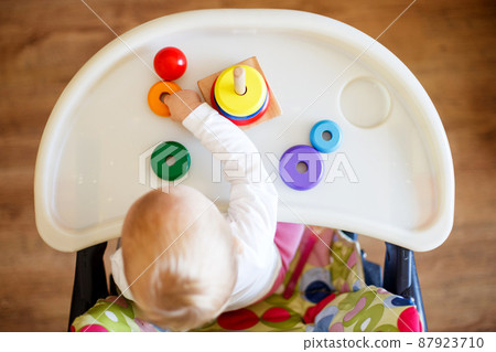 the kid plays the pyramid. child in the children's room playing with toys view from above the kid plays the pyramid. child in the children's room playing with toys view from above 87923710