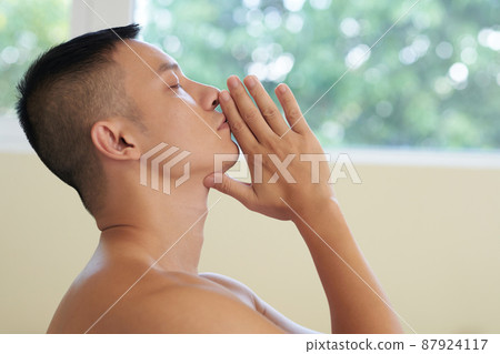 Man Practicing Meditation at Home Man Practicing Meditation at Home 87924117