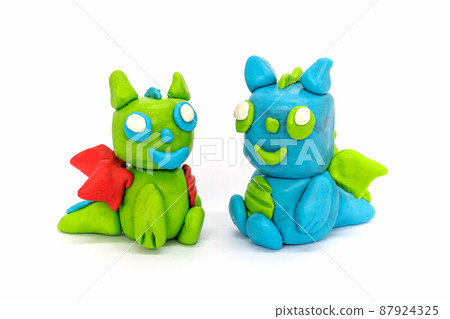 Play plasticine Dragon on white background. Handmade clay plasticine Play plasticine Dragon on white background. Handmade clay plasticine 87924325