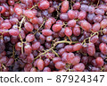 Bunch of colorful grapes with leaves 87924347