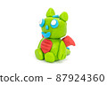 Play plasticine Dragon on white background. Handmade clay plasticine 87924360