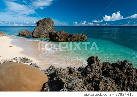 Beautiful hidden beach with white sands, rocks, crystalline emerald green sea. Yonaguni Island. Beautiful hidden beach with white sands, rocks, crystalline emerald green sea. Yonaguni Island. 87924415