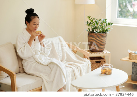 Woman Enjoying Cup of Tea 87924446