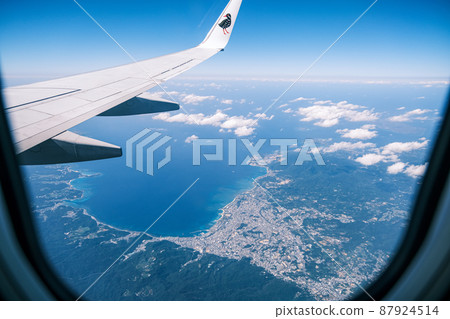 The tropical sea seen from the window of an airplane The tropical sea seen from the window of an airplane 87924514