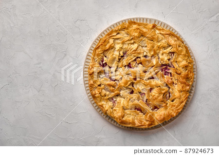 Homemade cherry pie from filo dough. Flat lay Homemade cherry pie from filo dough. Flat lay 87924673