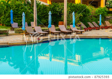 beach chair or pool bed with umbrella around swimming pool 87925393