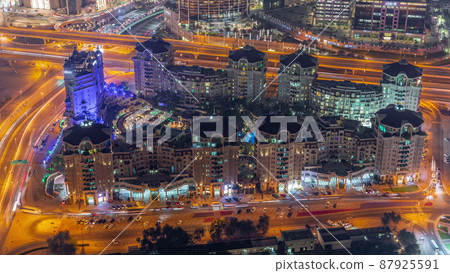 Bussy traffic on the overpass intersection in Dubai downtown aerial night timelapse. 87925591