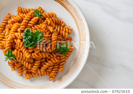 spirali or spiral pasta with tomato sauce 87925610