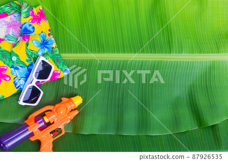 Songkran Festival background with jasmine garland Flowers in a bowl of water, perfume and limestone on a green wet banana leaf background. Songkran Festival background with jasmine garland Flowers in a bowl of water, perfume and limestone on a green wet banana leaf background. 87926535