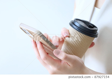 A woman touching a smartphone A woman touching a smartphone 87927154