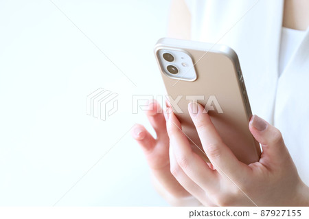 A woman touching a smartphone A woman touching a smartphone 87927155