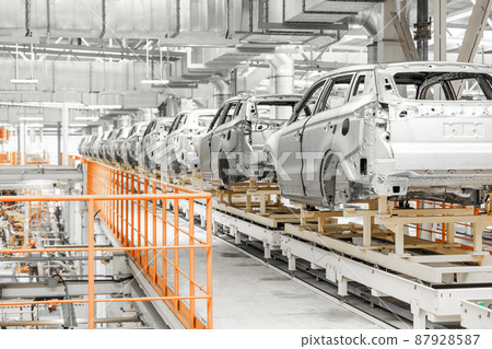 Photo of automobile production line. Welding car body. Modern car assembly plant. Auto industry Photo of automobile production line. Welding car body. Modern car assembly plant. Auto industry 87928587