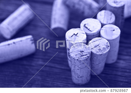 Dated wine bottle corks on the wooden background Dated wine bottle corks on the wooden background 87928987