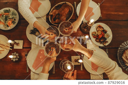 Happy friends clinking champagne glasses while celebrating New Years Eve or Christmas 87929016