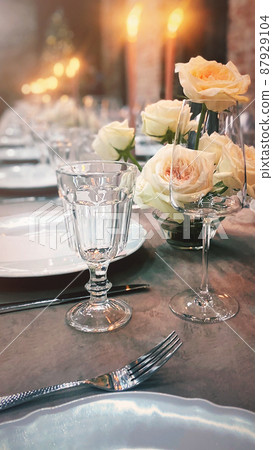 Amazing banquet table settings with floral arrangements for dinner party or wedding in restaurant Amazing banquet table settings with floral arrangements for dinner party or wedding in restaurant 87929104