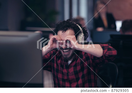 Funny businessman wearing headset having virtual team meeting group call chatting with diverse people in customer support. Video conference call on computer with manager and employees. 87929305