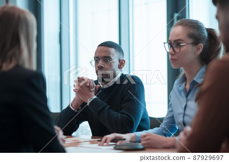 Successful team. Group of young multi-ethnic business people working and communicating together in creative office. Selective focus Successful team. Group of young multi-ethnic business people working and communicating together in creative office. Selective focus 87929697