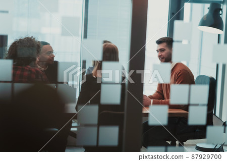 Successful team. Group of young multi-ethnic business people working and communicating together in creative office. Selective focus Successful team. Group of young multi-ethnic business people working and communicating together in creative office. Selective focus 87929700