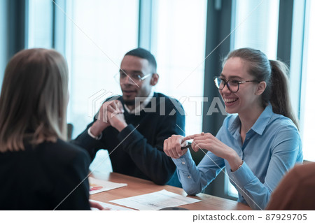 Successful team. Group of young multi-ethnic business people working and communicating together in creative office. Selective focus  87929705
