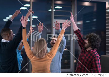 Overjoyed young multiethnic businesspeople have fun celebrate shared business success or victory in office. Smiling multiracial diverse employees feel excited win get good results. Teamwork concept. 87929813