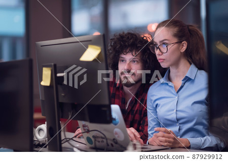 Smiling businesswoman experienced in work on business project training coaching man coworker, pleasant lady qualified consultant advisor assisting male client customer at laptop 87929912