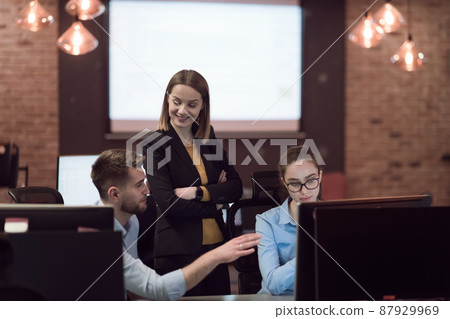 Business people team experienced in work on business project training coaching man coworker, pleasant lady qualified consultant advisor assisting male client customer at the computer. Business people team experienced in work on business project training coaching man coworker, pleasant lady qualified consultant advisor assisting male client customer at the computer. 87929969