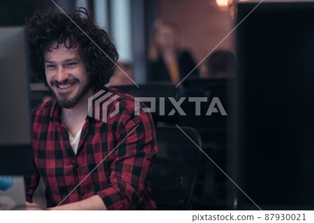 Smiling businessman wearing headset having virtual team meeting group call chatting with diverse people in customer support. Video conference call on computer with manager and employees. 87930021
