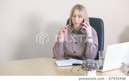 woman working in office. speaking by phone and thinking on client's message. real estate agency. woman realtor or loan adviser. copy space. woman working in office. speaking by phone and thinking on client's message. real estate agency. woman realtor or loan adviser. copy space. 87930496