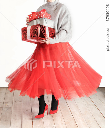 dancing woman wearing festive red clothes holding gift boxes. happy birthday, anniversary or holiday selebrating. crop view, sale shopping dancing woman wearing festive red clothes holding gift boxes. happy birthday, anniversary or holiday selebrating. crop view, sale shopping 87930498