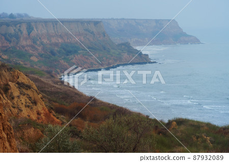 seascape in the evening - sea, waves, horizon and haze, view from high hills 87932089
