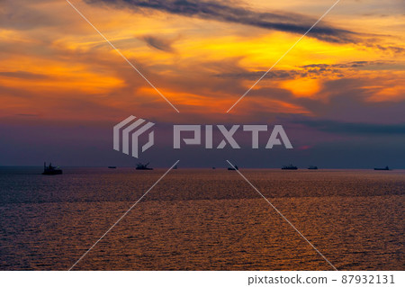 Beautiful sunset in the sea and ships. The sun shines through the clouds and is reflected in the waves Beautiful sunset in the sea and ships. The sun shines through the clouds and is reflected in the waves 87932131