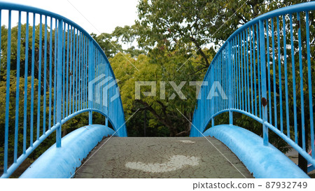 Blue railing pedestrian bridge Blue railing pedestrian bridge 87932749