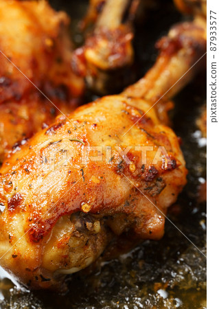 roasted chicken legs with aromatic crust, baked meat on a oven tray, tasty food close view roasted chicken legs with aromatic crust, baked meat on a oven tray, tasty food close view 87933577